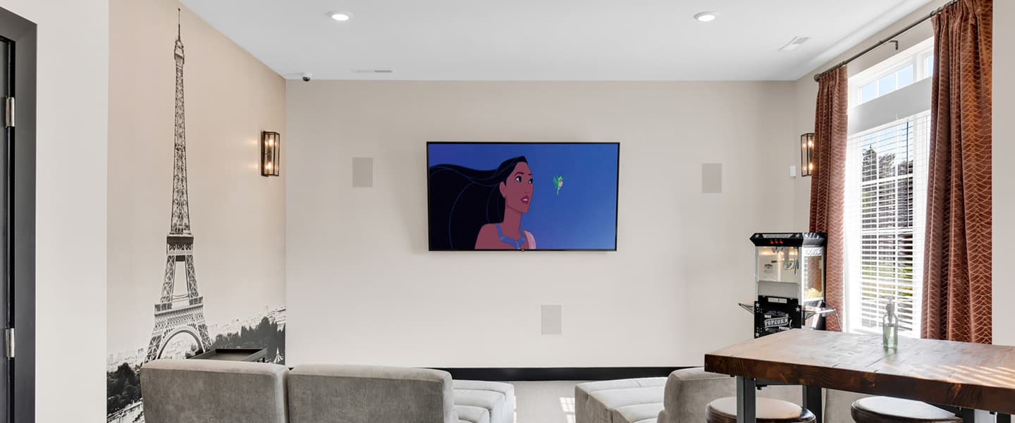 Common area at Woodfield Park featuring comfortable seating and a large TV for residents