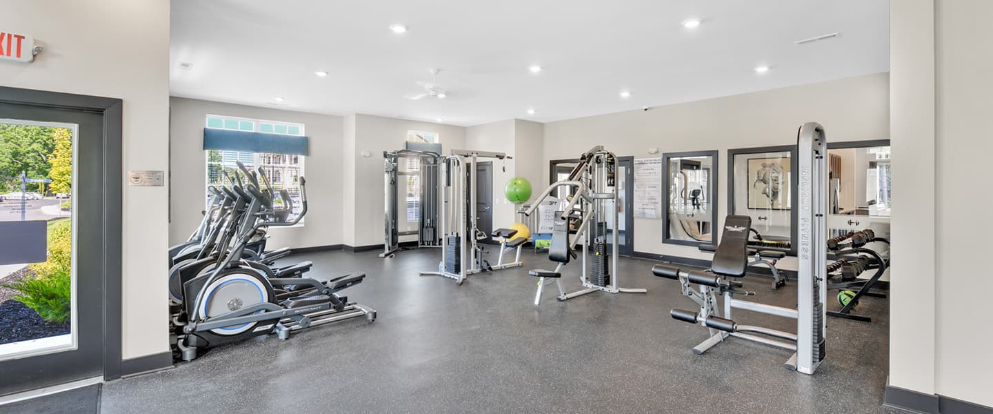 Large fitness center featuring a variety of exercise equipment