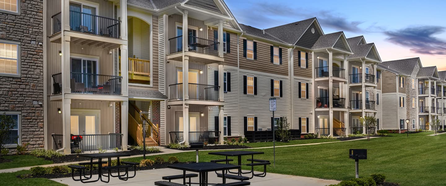 View of apartments with balconies and inviting outdoor seating