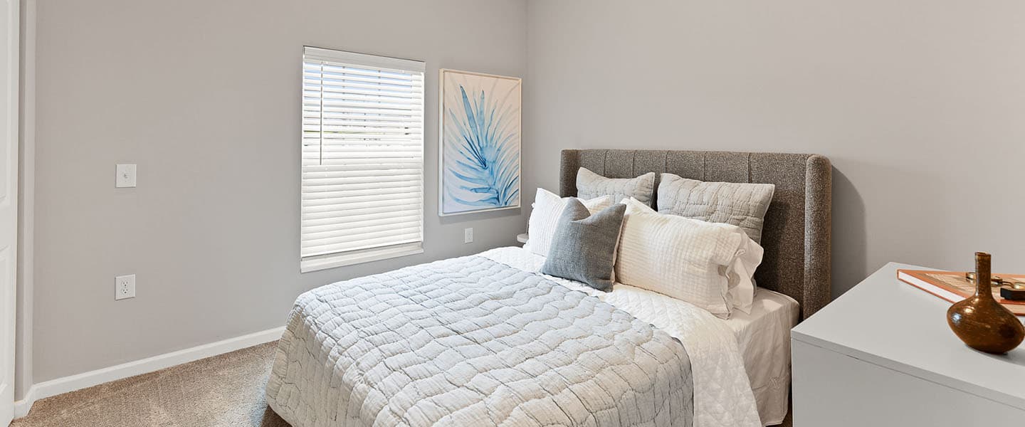 A cozy bedroom with decorative pillows and modern decor.