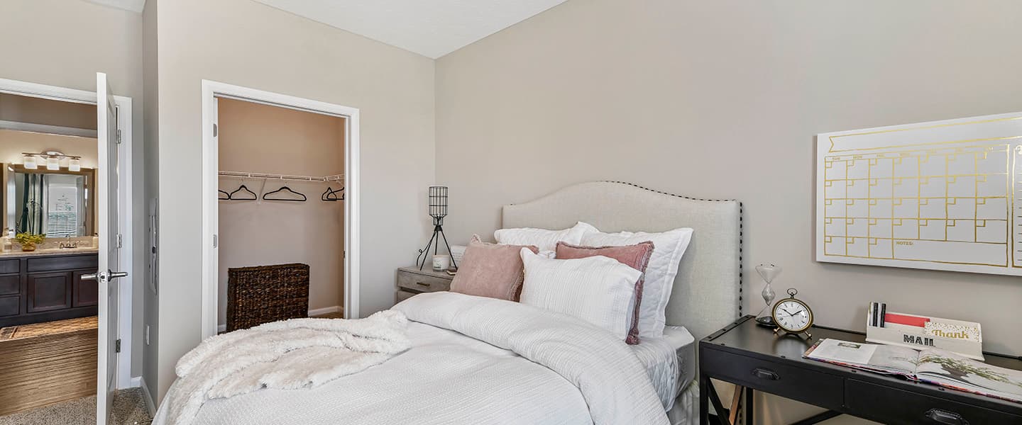 A cozy bedroom with decorative pillows and modern decor.