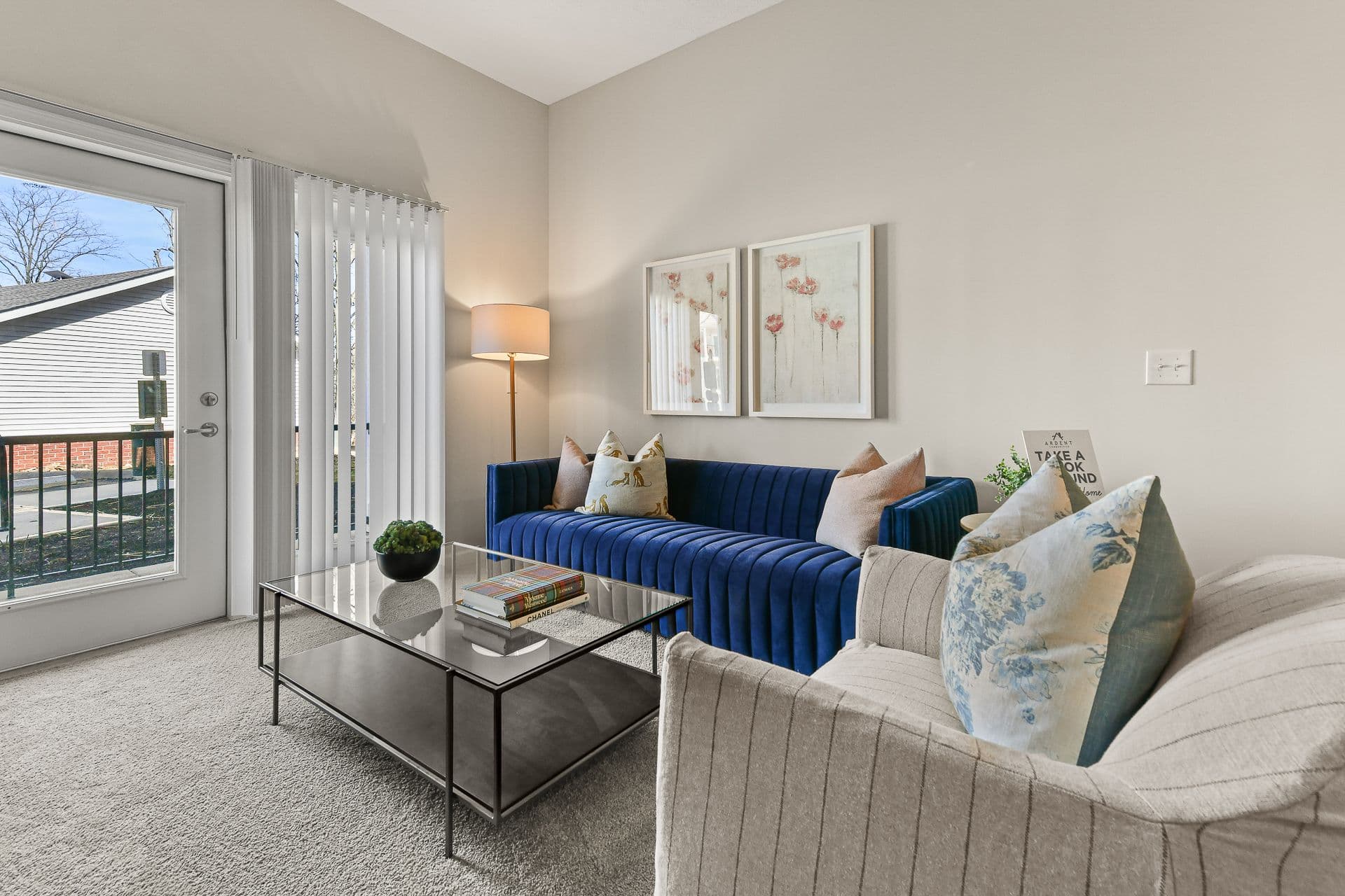 A living room with furniture and a connecting patio