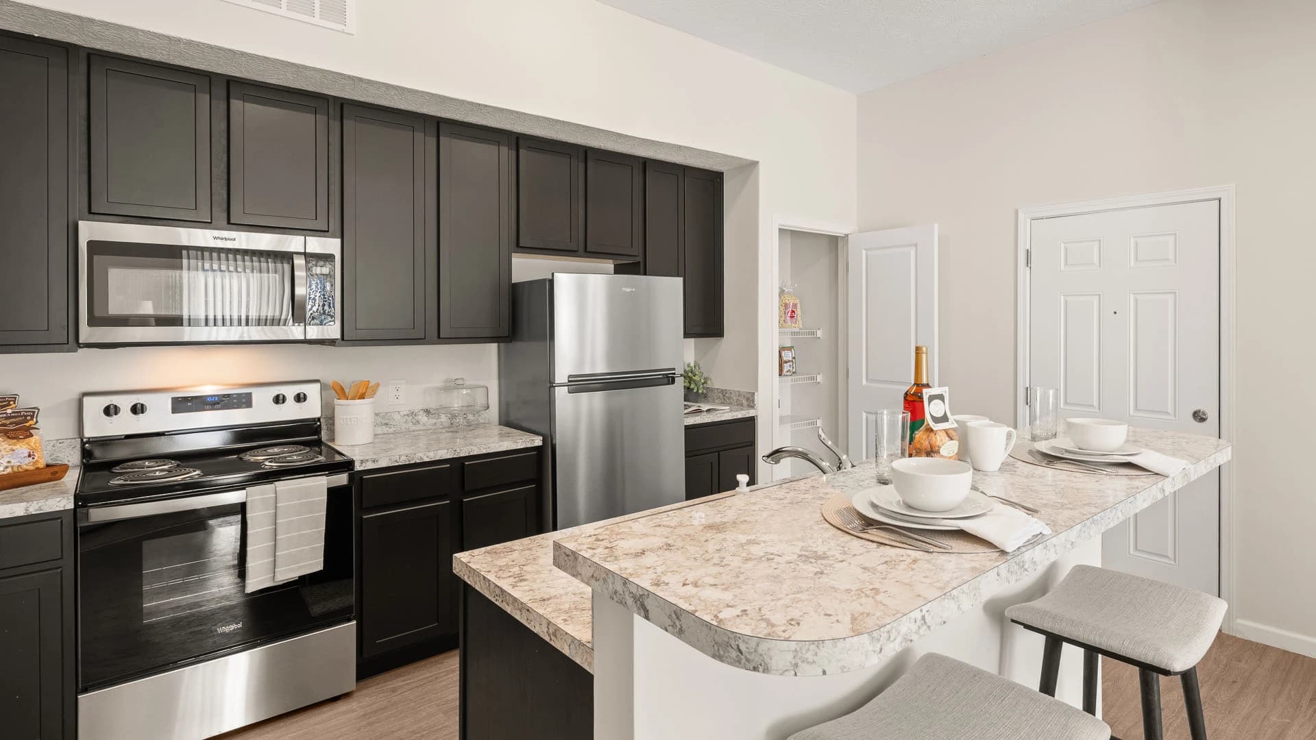 Modern kitchen appliances and island in a Grove City apartment unit