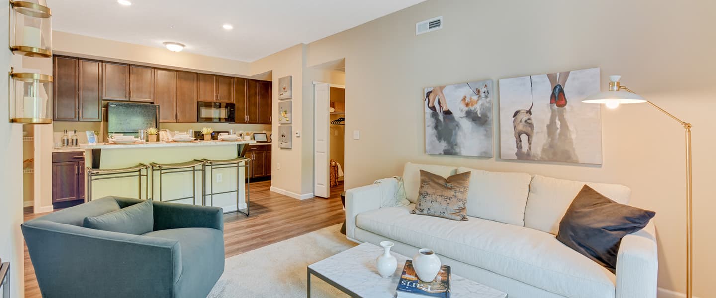 Living room with modern kitchen featuring open layout and stylish finishes