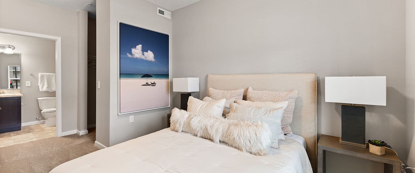 A cozy bedroom with decorative pillows and modern decor.