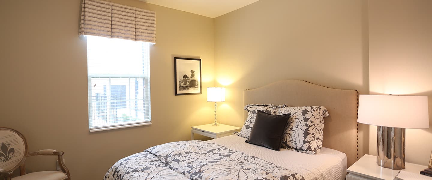 A cozy bedroom with decorative pillows and modern decor.