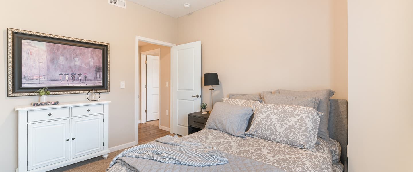 A cozy bedroom with decorative pillows and modern decor.