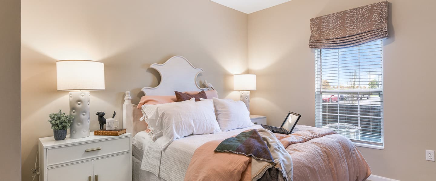 A cozy bedroom with decorative pillows and modern decor.