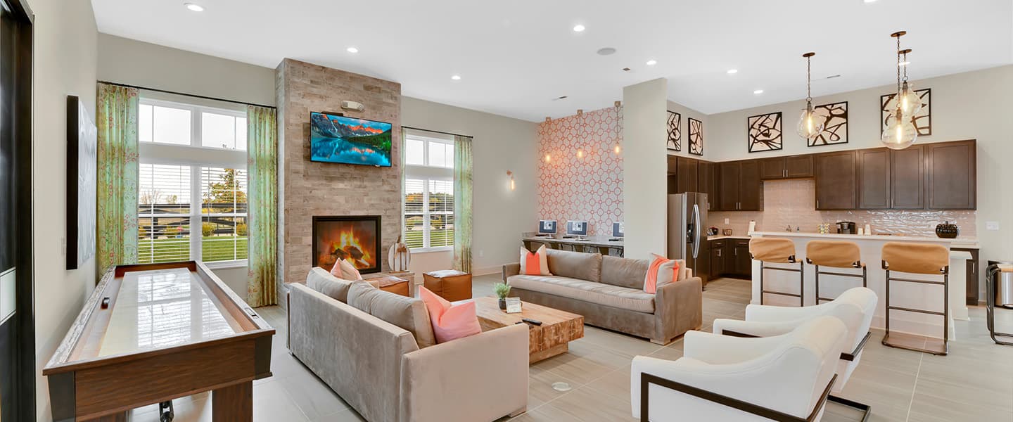 A community space complete with furniture, modern decor and a fireplace.