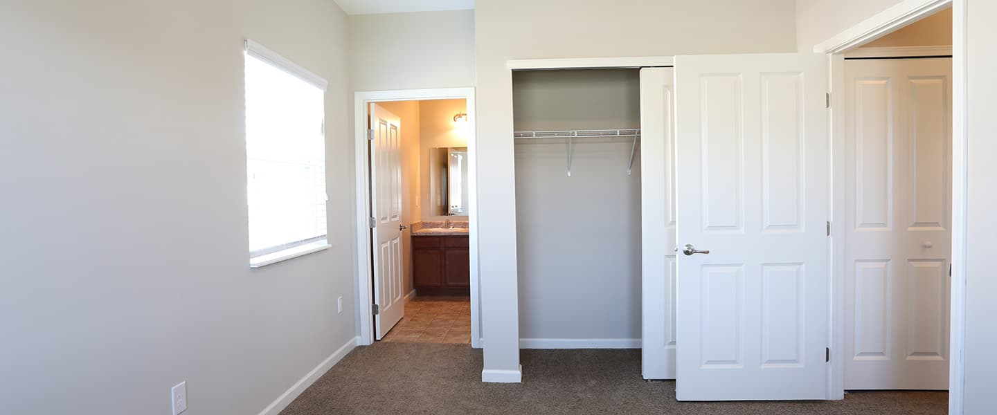 A newly renovated bedroom with access to a master bathroom and living room.