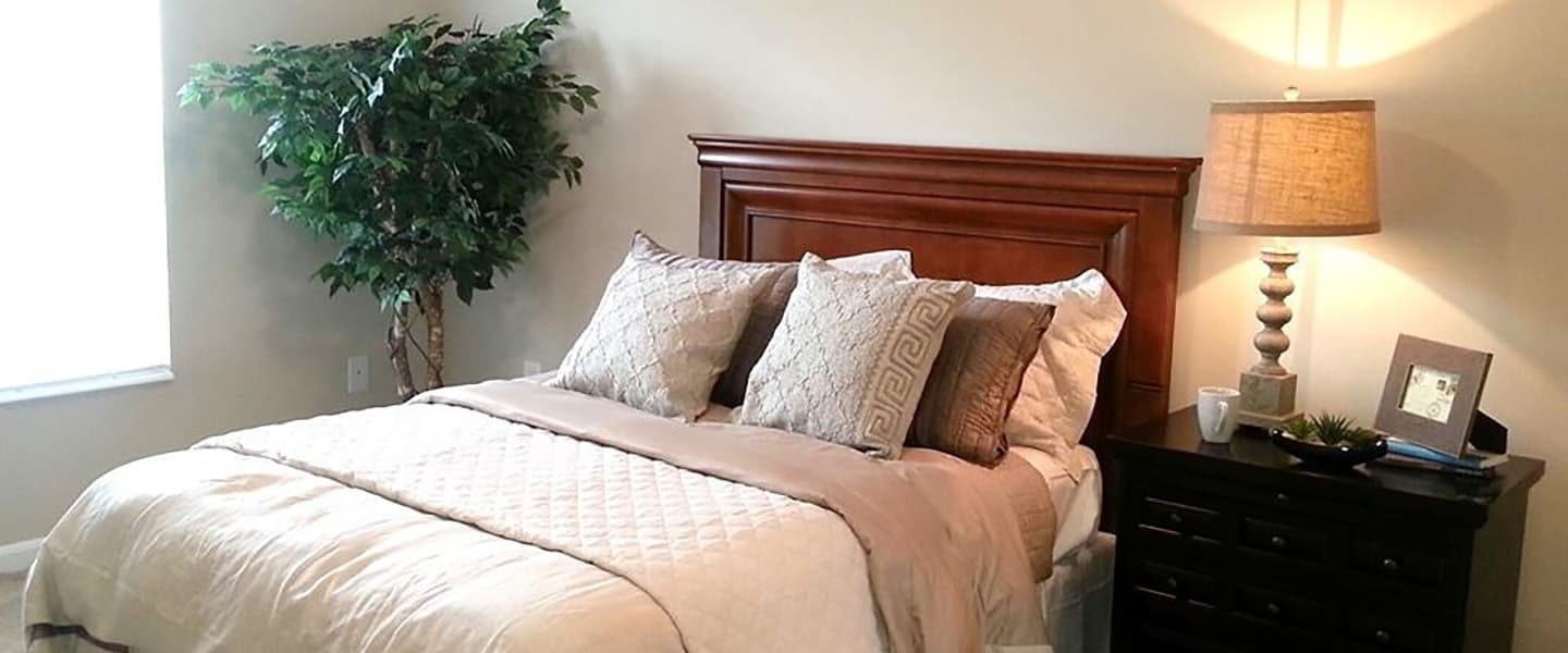 A cozy bedroom with decorative pillows and modern decor.