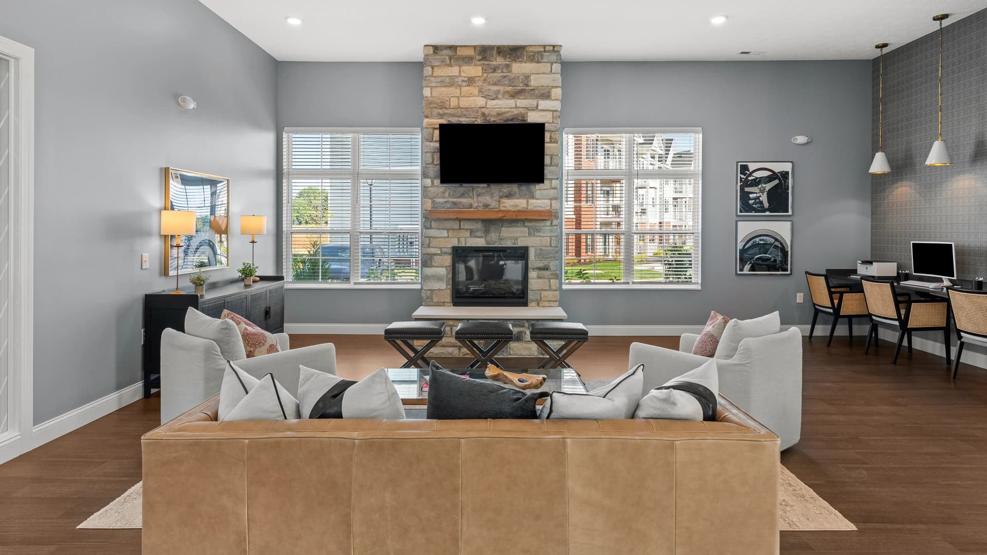 Lounge area with a couch, TV and computers for use by residents of an Etna Ohio apartment community