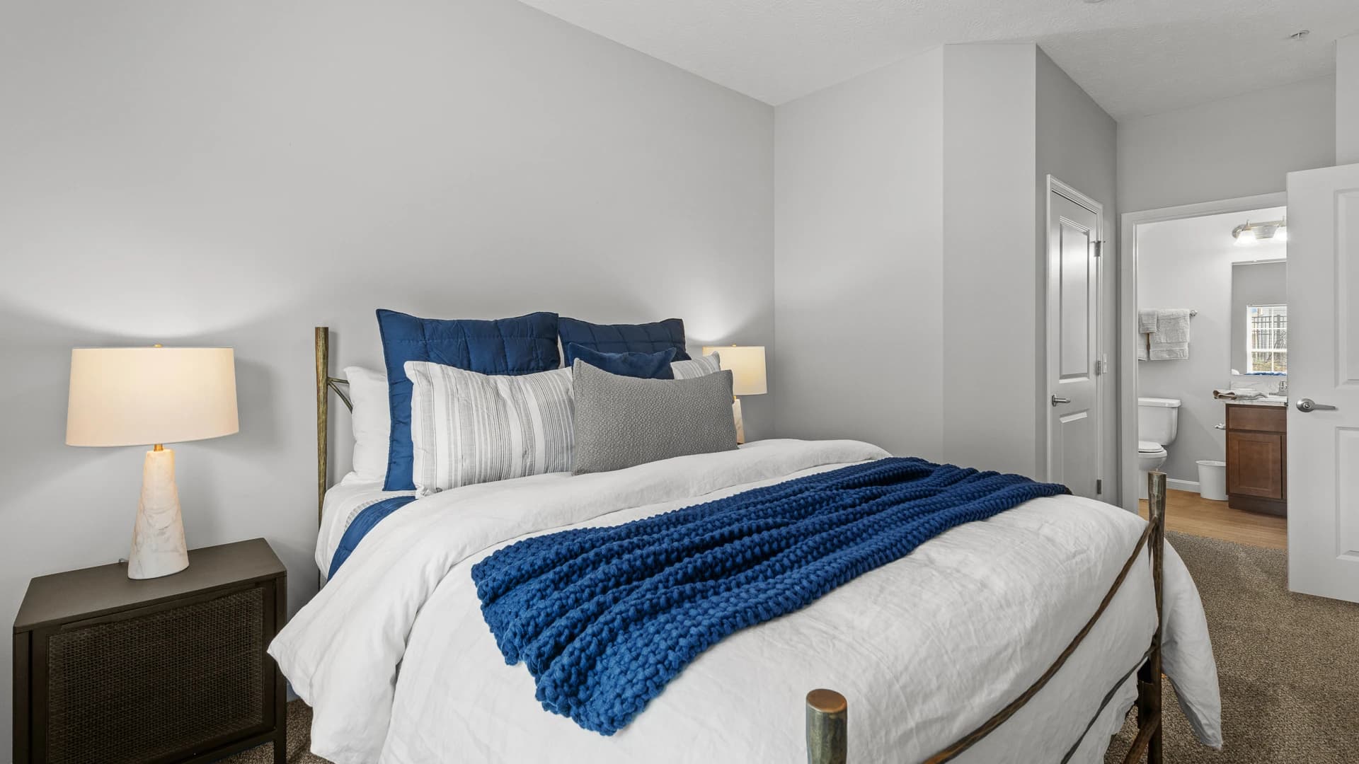 Comfortable master bedroom scene with bed and bathroom in an Etna Ohio apartment