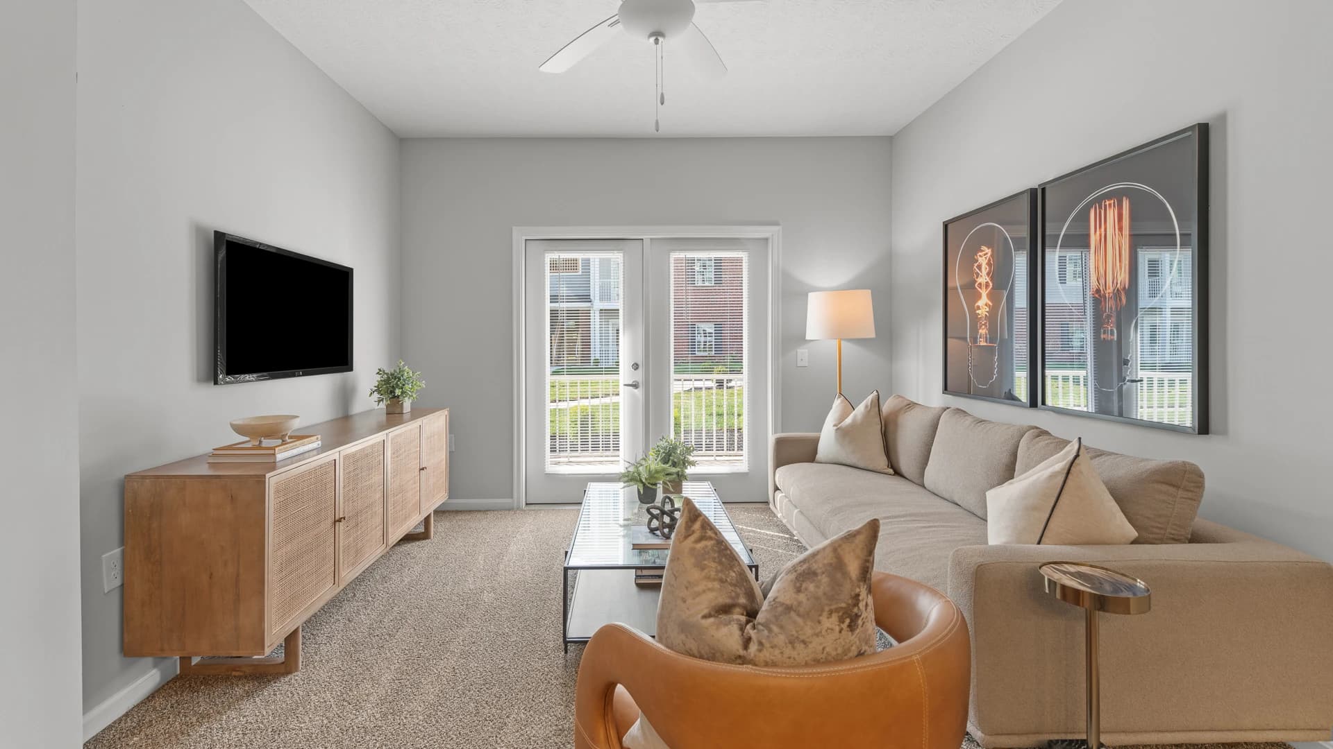 View of a modern living room with French doors leading to a patio area in an Etna Ohio apartment
