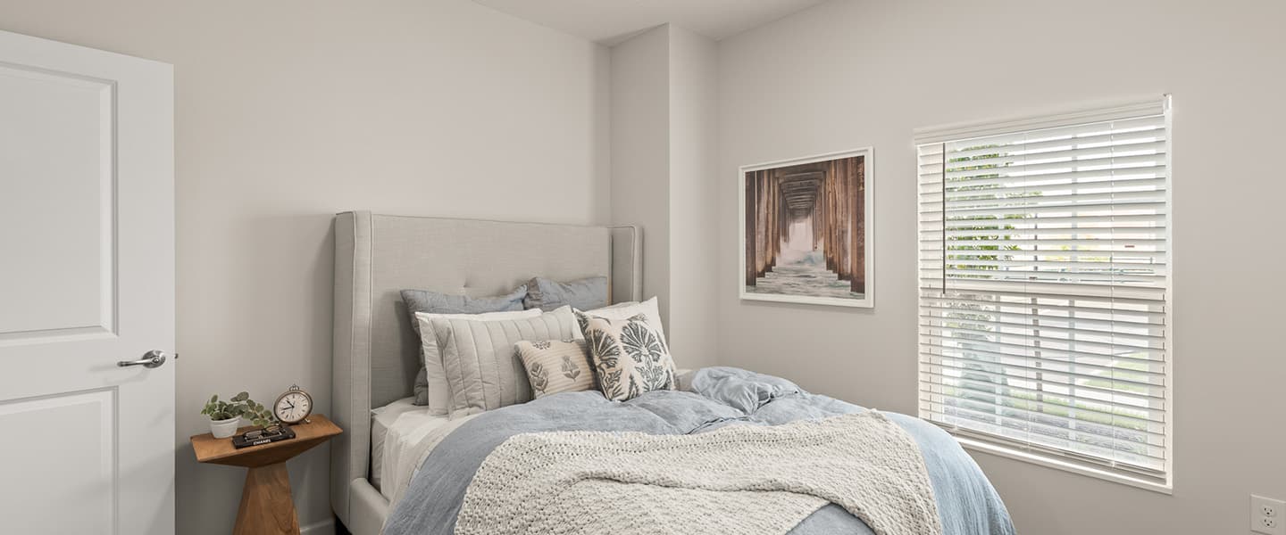 Bed and nightstand next to a window in a Powell Ohio apartment
