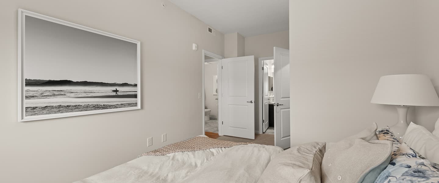 View from a bed of the entrance to attached bathroom and walk-in closet of a Powell Ohio apartment