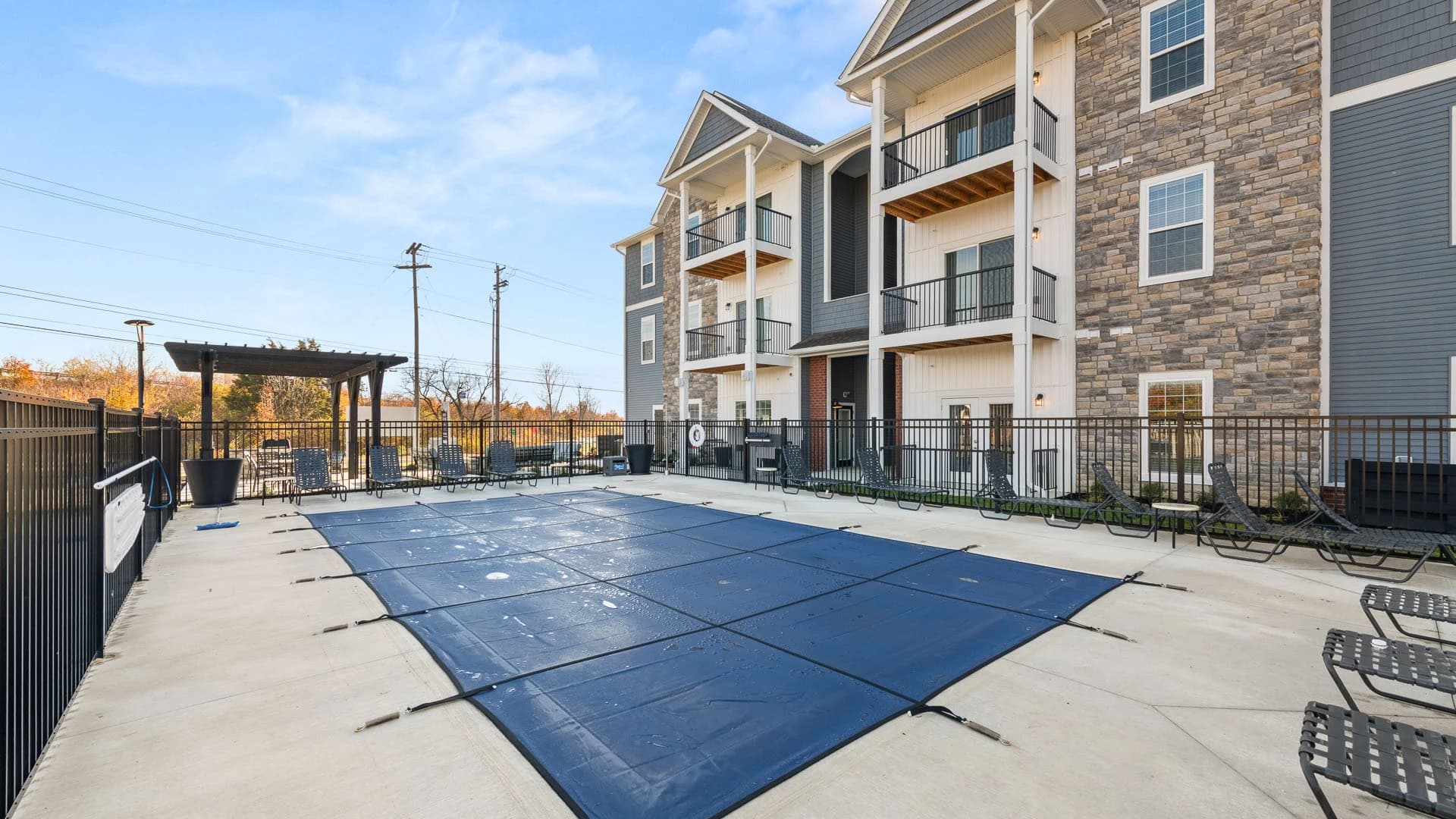 Outdoor swimming pool (with cover on) attached to a Grove City apartment complex