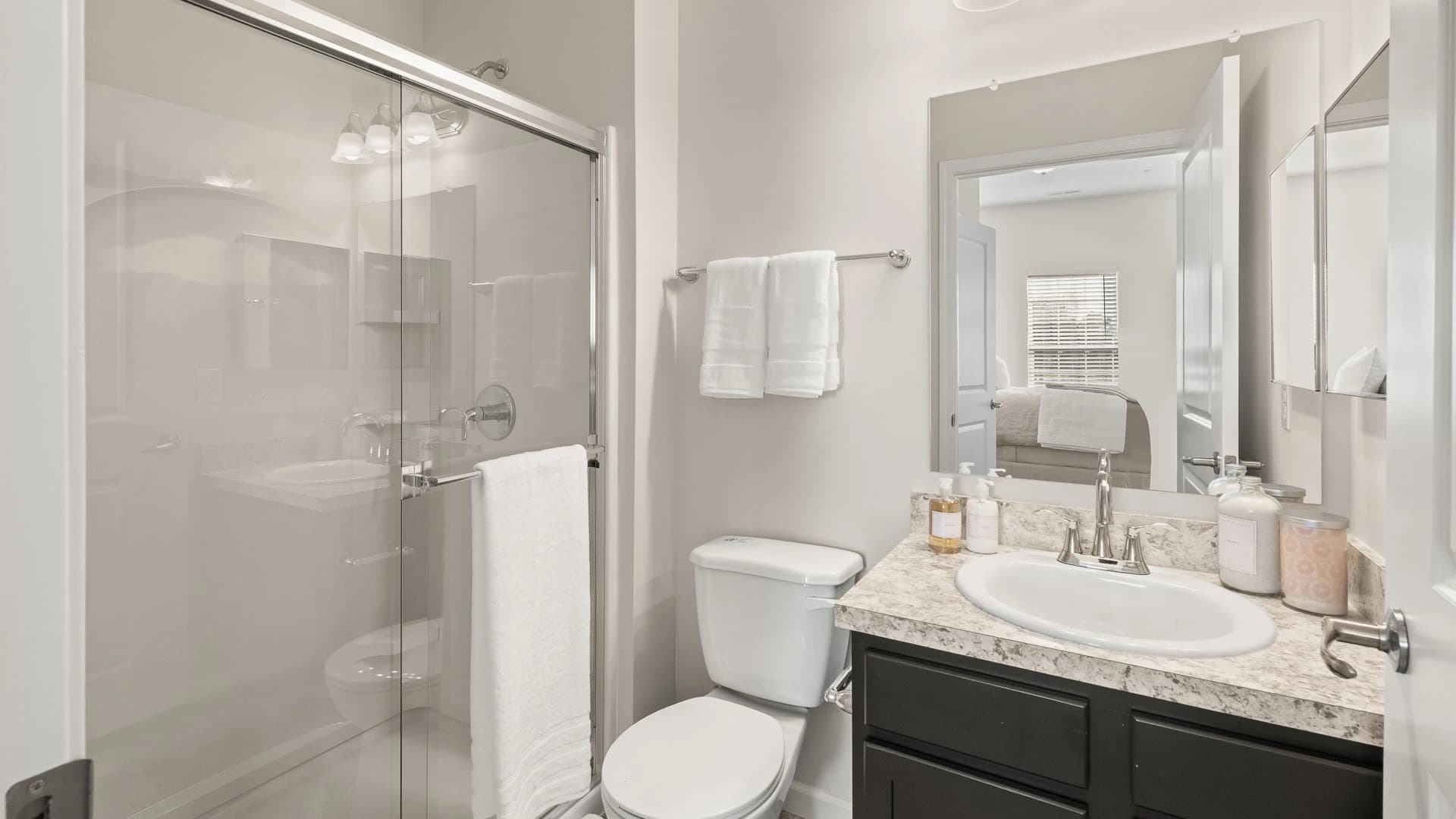 Master bathroom with vanity, toilet and glass shower area in a Grove City Ohio apartment unit