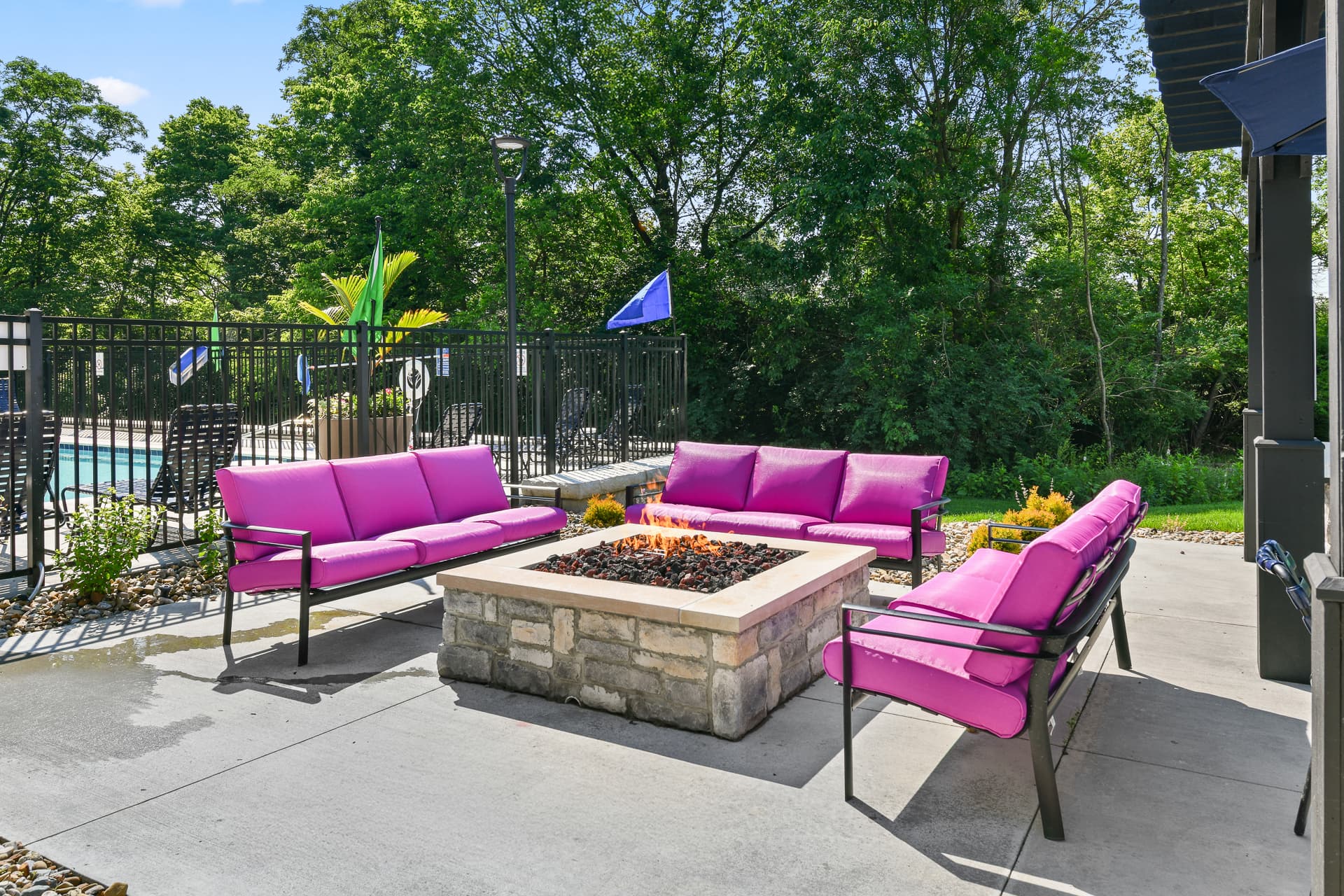 Outdoor seating around a firepit next to the pool
