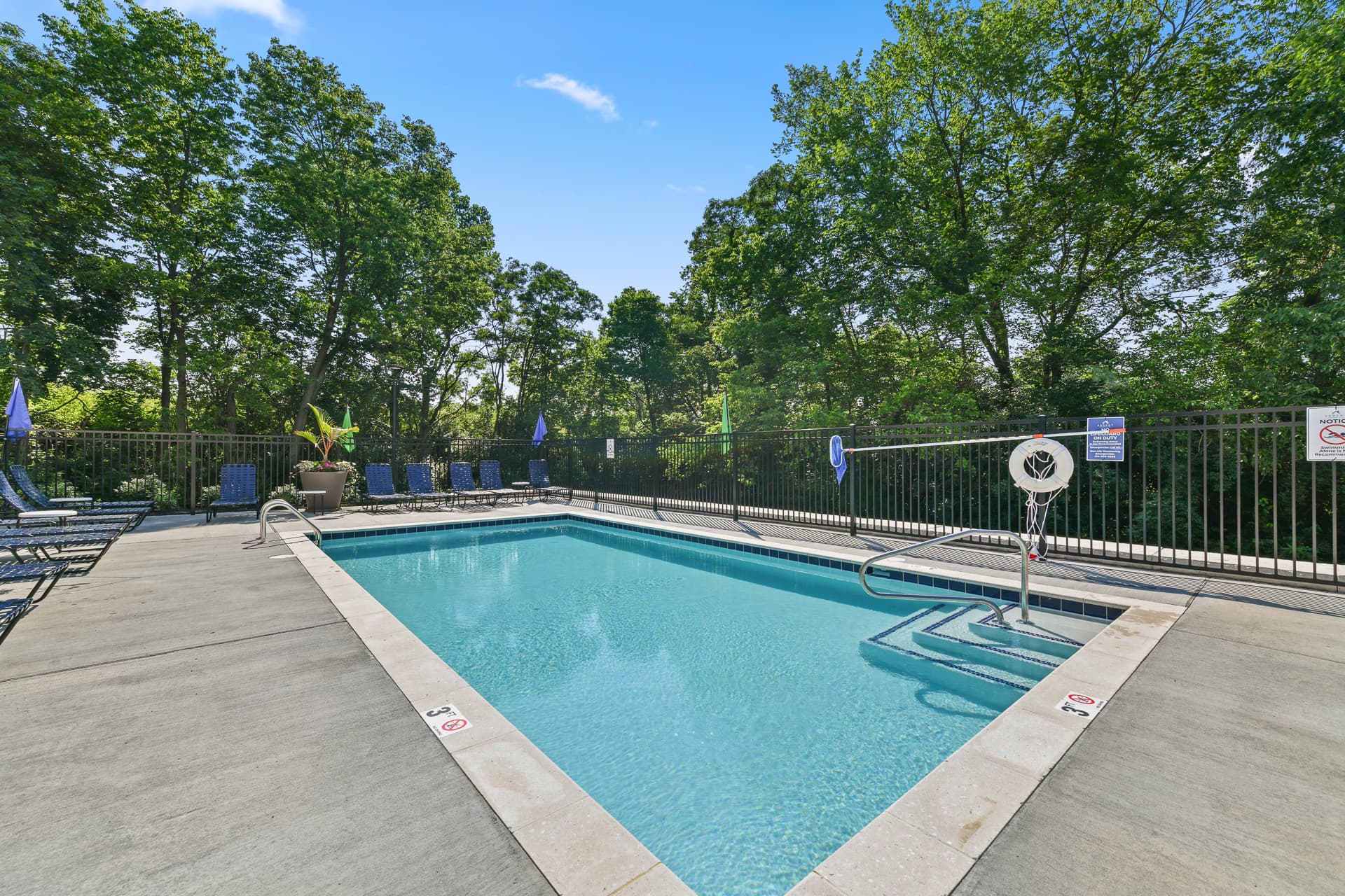Swimming pool surrounded by lounge chairs.