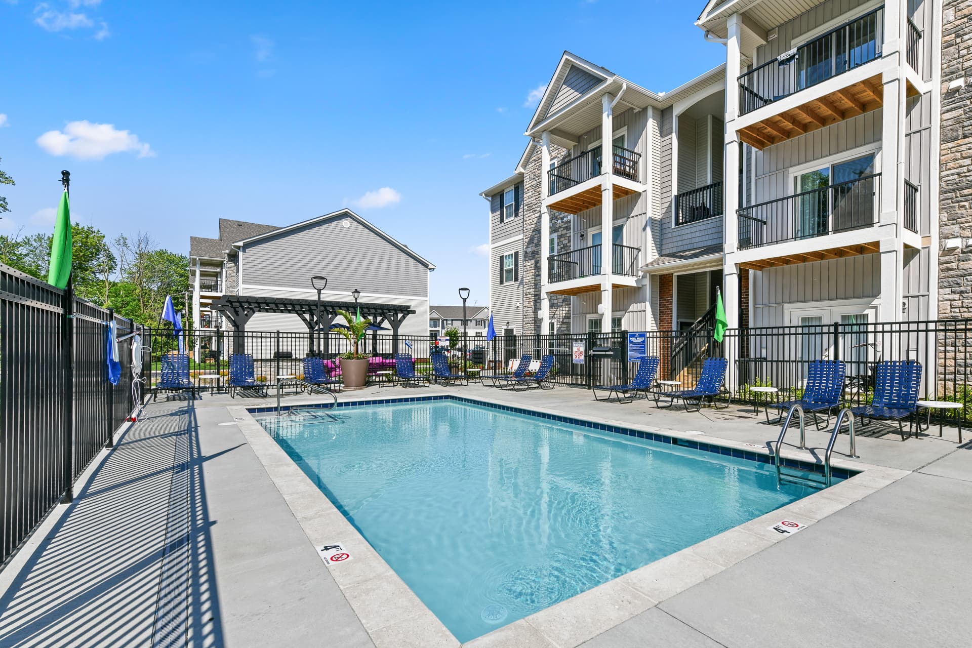Outdoor pool with seating areas for residents to swim and relax.