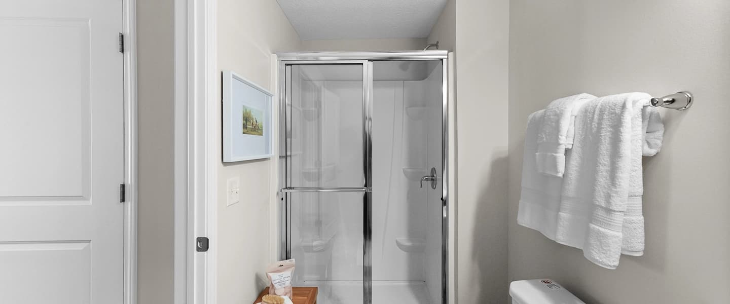 Bathroom featuring a walk-in shower with modern fixtures and sleek design